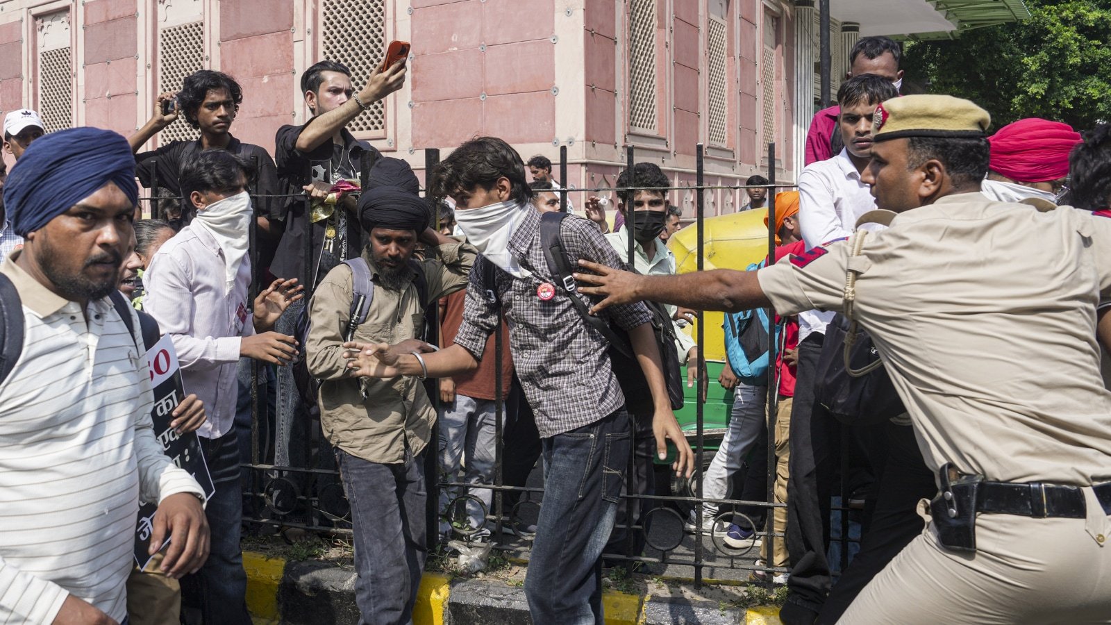 A Delhi Police official pushes back demonstrators during an agitation called by CJP against CEC Gyanesh Kumar, in New Delhi on Saturday. (PTI Photo) A Delhi Police official pushes back demonstrators during an agitation called by CJP against CEC Gyanesh Kumar, in New Delhi on Saturday. (PTI Photo)